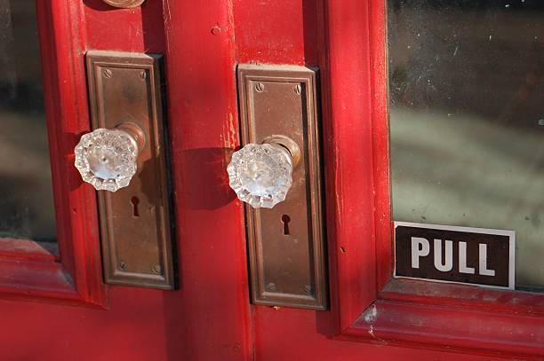 Antique red door with glass knobs stock photo
