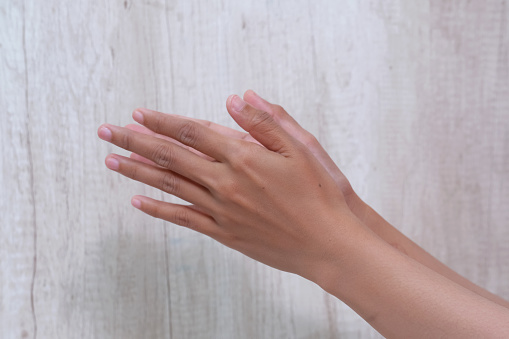 Young woman's hands on a white abstract background