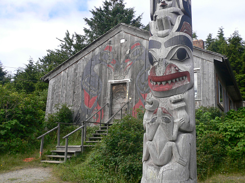 Totem and old house in Old Masset, Queen Charolette Islands, BC, Canada