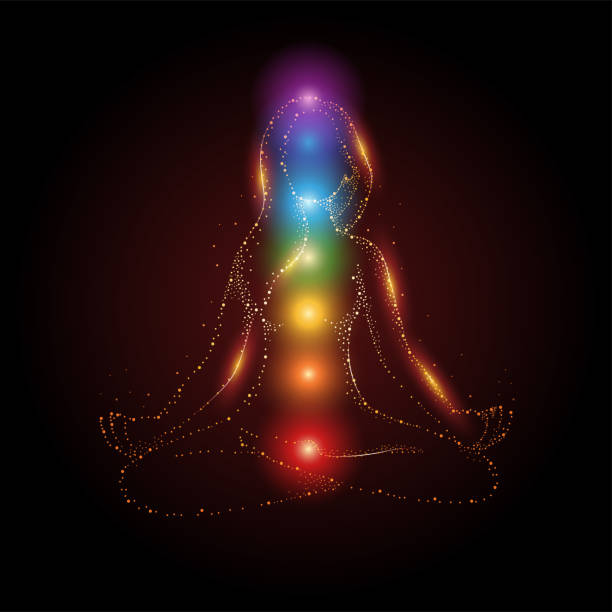 Female figure meditating in lotus position with colorful 7 chakras Particles of female figure meditating in lotus position with colorful 7 chakras and aura glow, vector illustration chakra stock illustrations