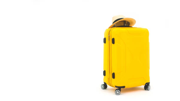 istock Yellow travel luggage with hat on isolated white background 1399858892