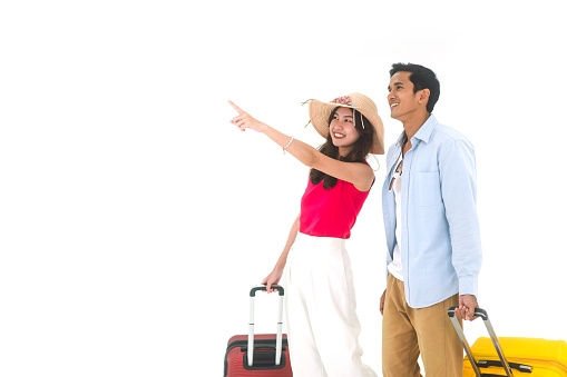 Happy smile young adult asian travel couple carry luggage on isolated white background. People departure for holidays summer trip concept.
