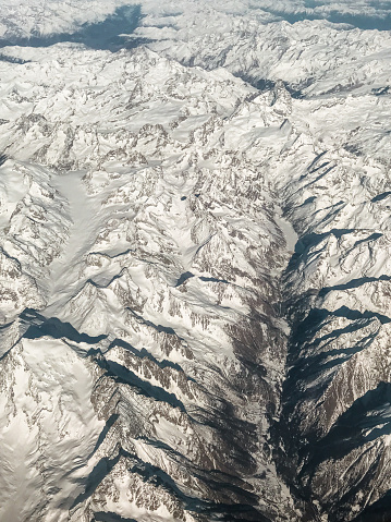 snowcapped alps mountains from the airplane