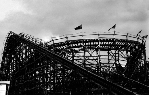A silhouetted roller coaster, taken on high speed black and white film for dramatic effect.