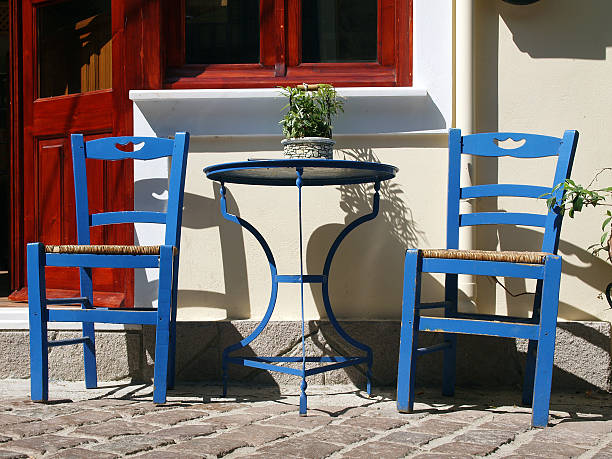 two blue greek chairs with table stock photo