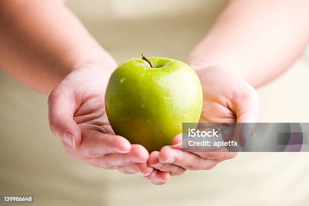 Two Hands Holding A Green Apple Stock Photo - Download Image Now - Adult, Apple - Fruit, Drop