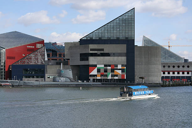Baltimore Inner Harbor Aquarium a view of the Baltimore Inner Harbor facing the National Aquarium, the USS Torsk (submarine) and a passing water taxi.  (a popular travel / tourist destination) watertaxi stock pictures, royalty-free photos & images