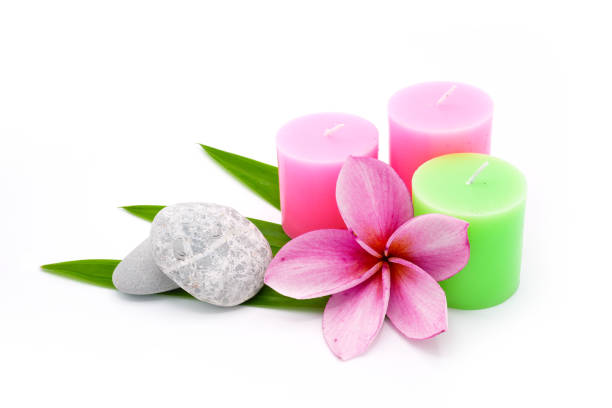 istock Frangipani flower and Aroma candles isolated on white. 1399869315