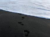 Footsteps on the beach sand