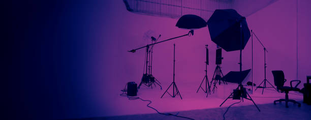 Studio video production lighting set. Behind the scenes shooting production set up by crew team camera and equipment in studio. Video production filming or commercial movie film live streaming online.
