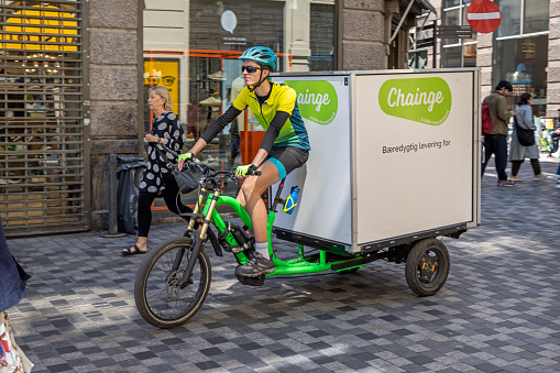 Man on a cargo bike from a parcel delivery firm in the center of Copenhagen. This kind of transport is growing increasingly more popular as traffic and pollution problems grow