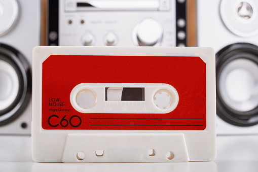 Audio cassette tape with hi-fi stereo player at the background