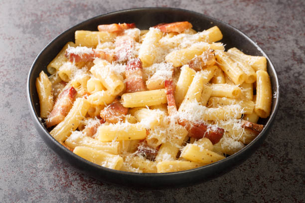 이탈리아 파스타 알라 그리시아 (italian pasta alla griciaa)는 강판 페코리노 로마노와 관시아 일 클로즈업을 곁들인 접시에 담겨 있습니다. 가로 - pancetta 뉴스 사진 이미지
