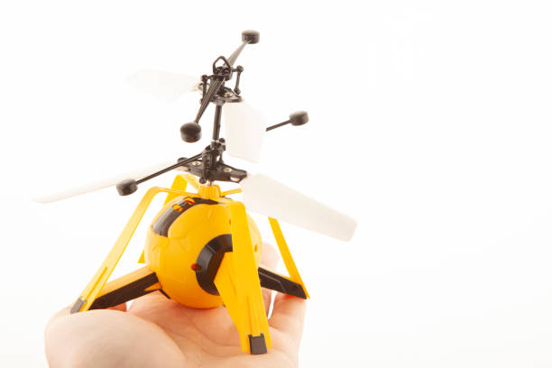 istock image of toy helicopter hand white background 1399877261