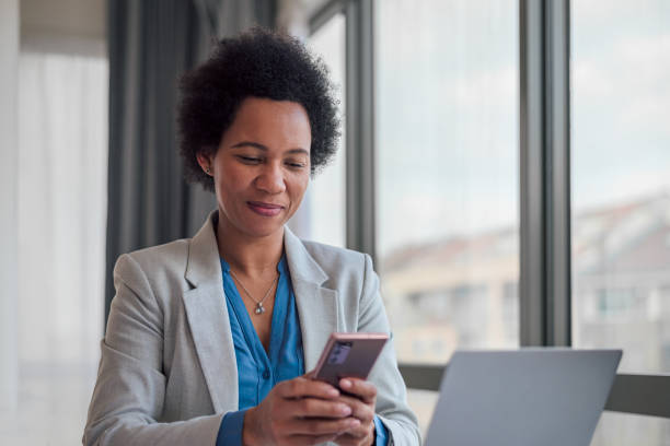 istock Confident female professional text messaging on smart phone at office. 1399879320