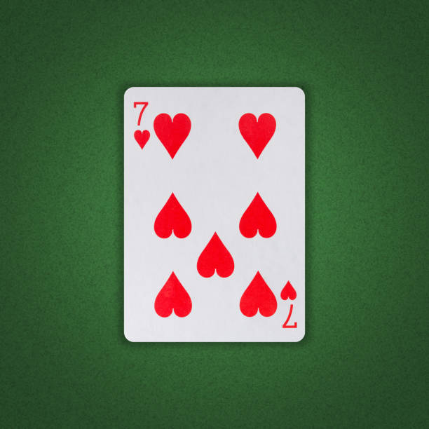 seven of hearts on a green poker background. gamble. playing cards. - rummy leisure games number color image imagens e fotografias de stock