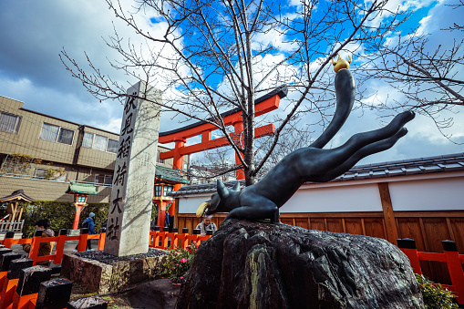 Kyoto, Japan - January 03, 2020: Stone Statue of Inari God Fox in Fushimi Inari Shrine Temple