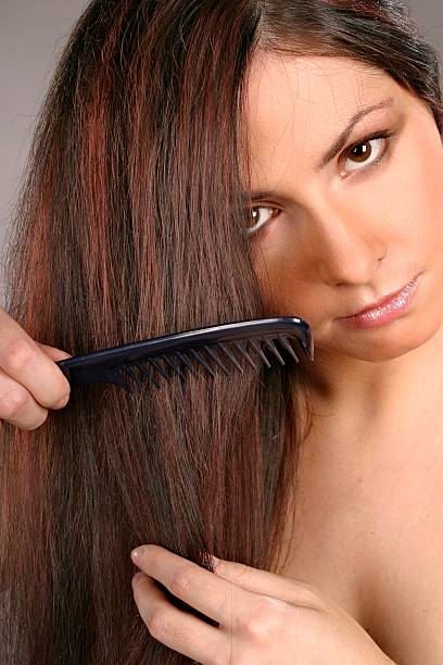 istock woman brushing hair 139988466