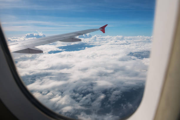 istock Cloudscape view from window of flying airplane 1399885409