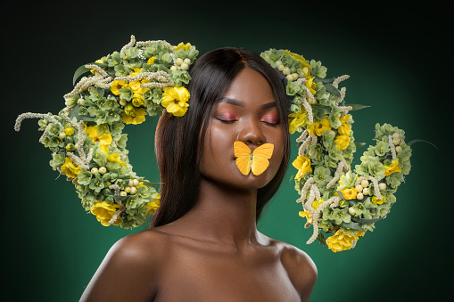 Studio portrait of a beautiful young African Flower Queen wearing a unique headpiece