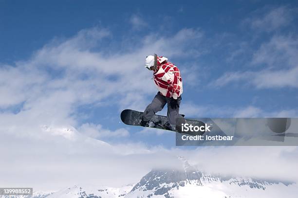 Snowboarder Jumping High In The Air Stock Photo - Download Image Now - Activity, Adult, Blue