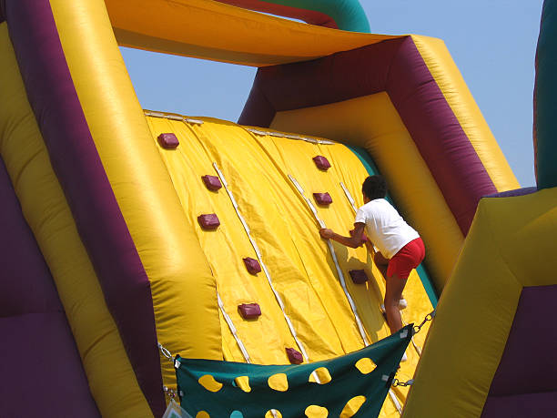 istock Child climbing up an inflatable climbing wall 139988753