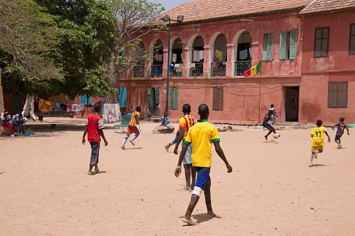 Dakar, Senegal - May 27, 2014: Young people playing football in a field on Goree Island