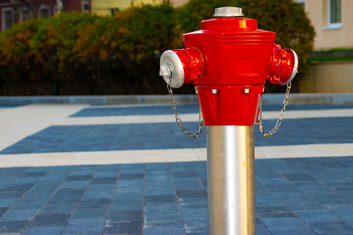 red fire hydrant on the sidewalk in the city. selective focus