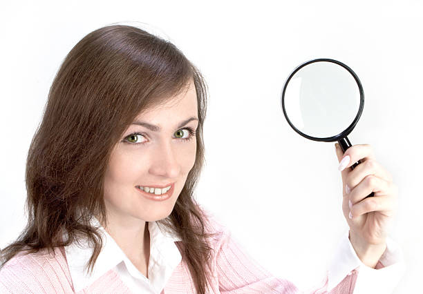 istock Young Woman with Magnifying Glass 139989084