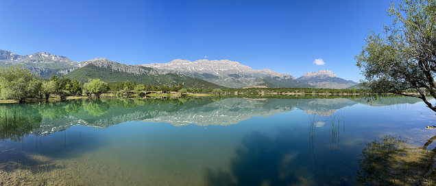 Panoramic photo of the fascinating, mystical and magnificent pond with the mountains