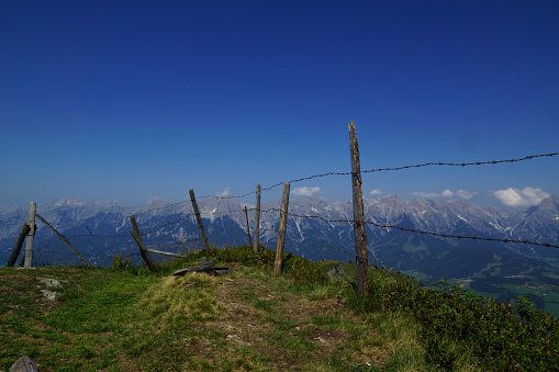 Mountain panorama with fence and blue sky