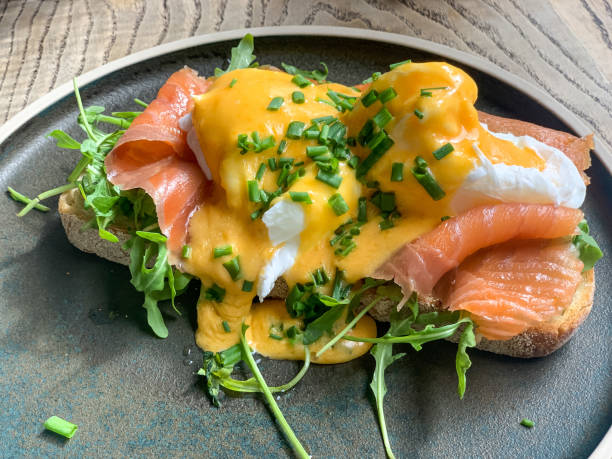 istock Eggs benedict with smoked salmon rocket on toast. Breakfast in cafe 1399891938