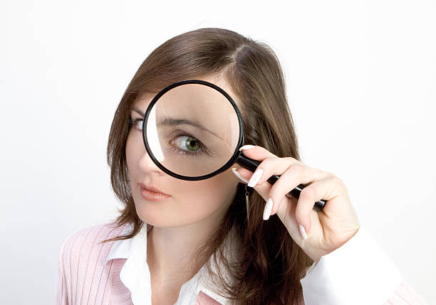 istock Young Woman with Magnifying Glass 139989206