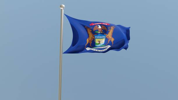 istock Michigan flag on flagpole. MI flag fluttering in the wind. 1399892951