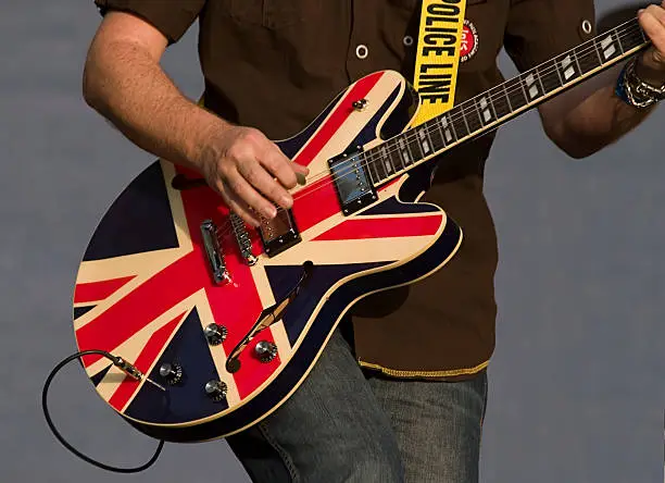 British flag colored guitar being played live on stage