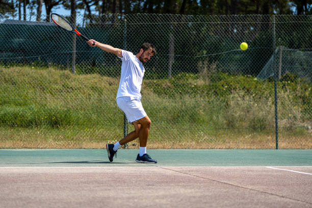 istock Tennis player hitting backhand at ball 1399893690