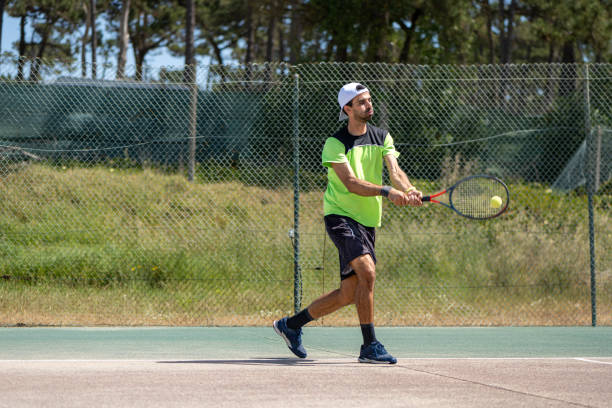 istock Tennis player hitting backhand at ball 1399893800