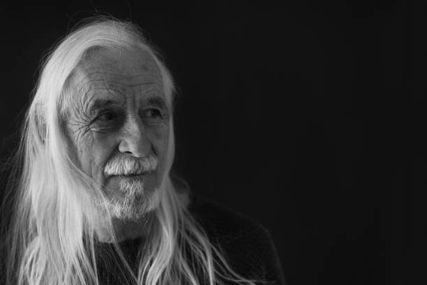 istock Low key black and white portrait of smiling old man 1399893903