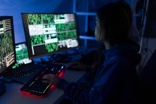 istock Young woman hacker by computer in the dark room at night, cyberwar concept. 1399895797
