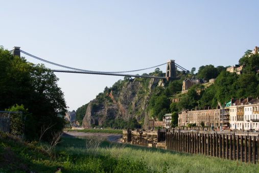 Suspension bridge in Bristol with the river Avon and houses in Hotwells