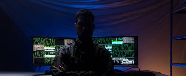 istock Anonymous hacker in military unifrorm on dark web, cyberwar concept. 1399895905
