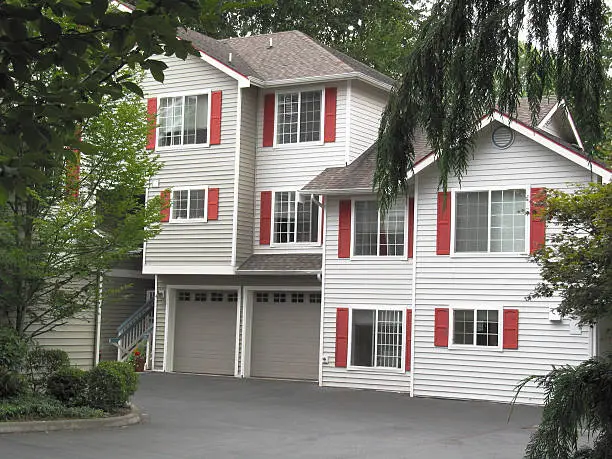 A modern apartment house sets among the trees.