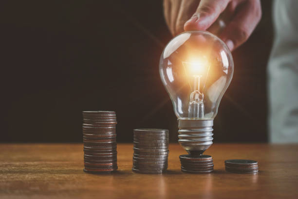 istock business man hand touch lightbulb and money stack, Saving money, saving money concept putting money coin stack growing business concept, Business, finance, investment, Financial planning. 1399896999