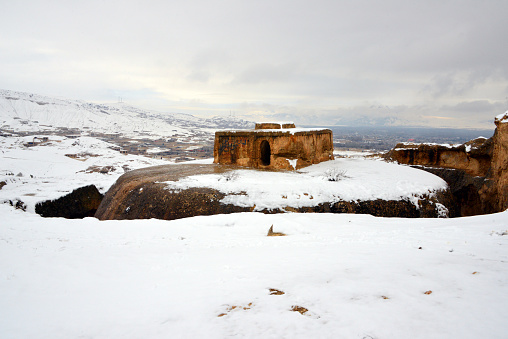 Takht-e Rustam, Aybak, Samangan Province, Afghanistan: Takht-e Rustam, meaning 'Rustams throne', Buddhist stupa cut into a mountain, part of a stupa-monastery dating from the Kushano-Sasanian period 4th-5th century AD, it was excavated by a Japanese archaeological mission in 1959 - the square building atop the stupa is the 'Harmika', it once held relics of the Buddha. The circular corridor was used by pilgrims for circumambulation. Afghan Lalibela.