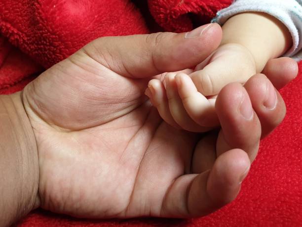 istock Hands of small new born Child 1399897271
