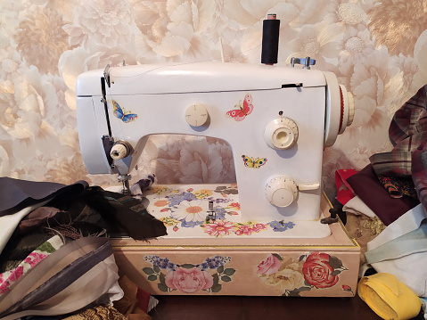 Tailor home work on sewing machine. Handmade fashion equipment.