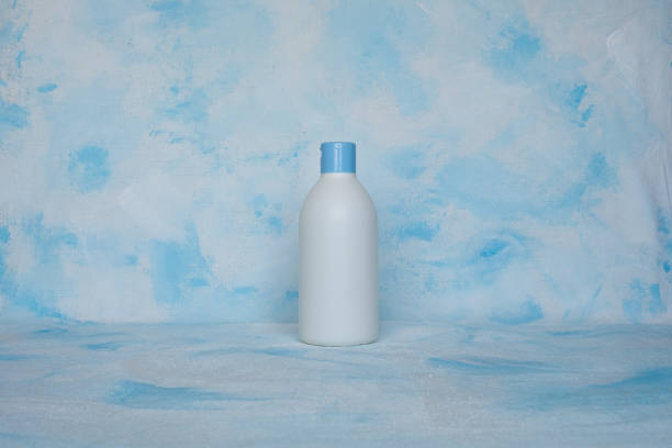 bottle for cosmetic products without a label. facial skin care concept. texture - liquid soap blue plastic textile imagens e fotografias de stock