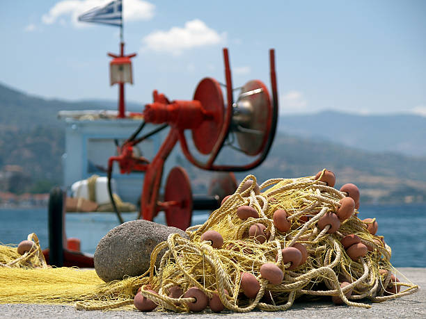 fishnet before old greek ship stock photo