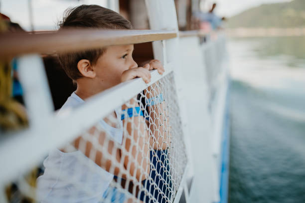 istock Little curious boy looking at water from motor boat. 1399900167