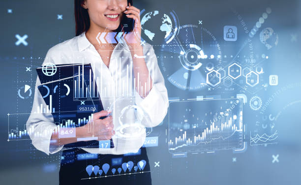 istock Businesswoman is talking on smartphone watching at digital interface 1399905411